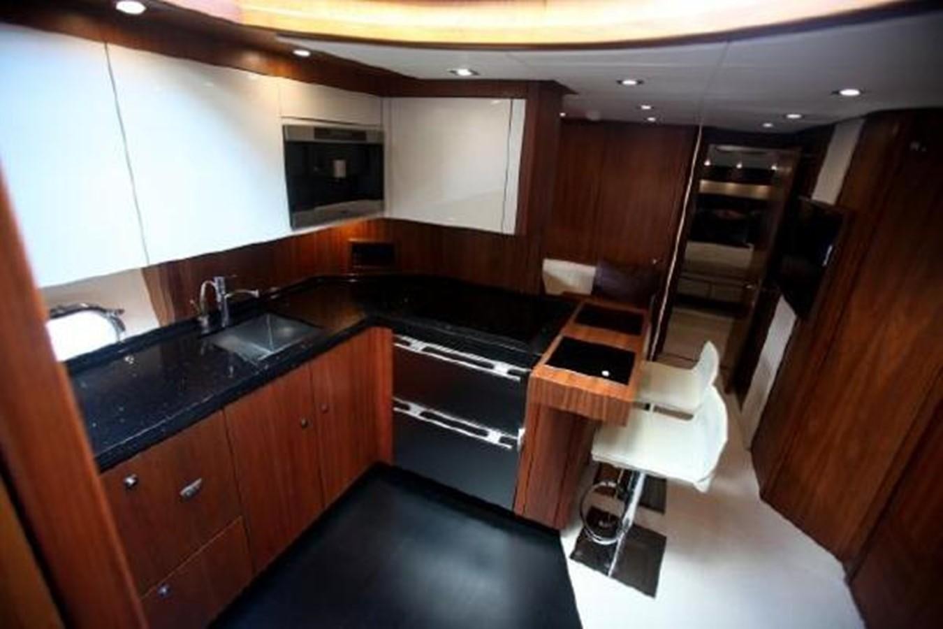a kitchen with black counters aboard SAM JADE Yacht for Sale