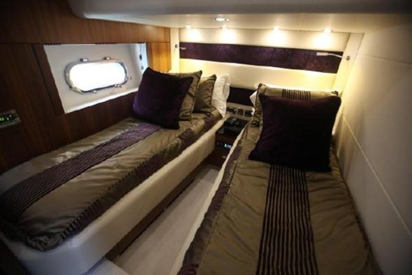 a bed with pillows and a mirror aboard SAM JADE Yacht for Sale