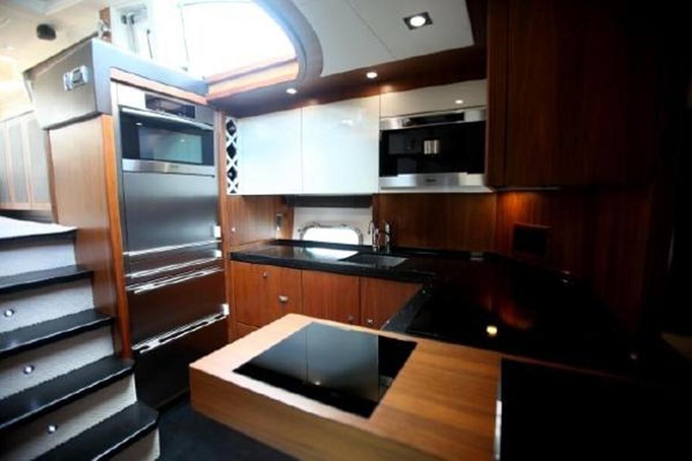 a kitchen with a microwave oven and a sink aboard SAM JADE Yacht for Sale