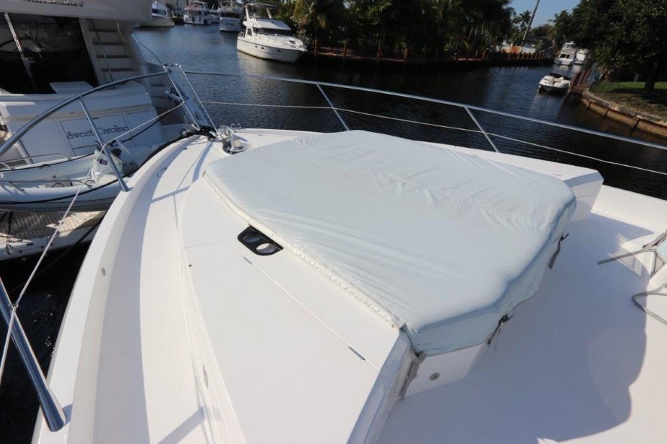 a white boat on a river aboard HIDE OUT Yacht for Sale