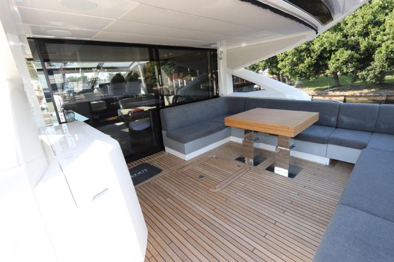 a room with a couch and a table aboard HIDE OUT Yacht for Sale