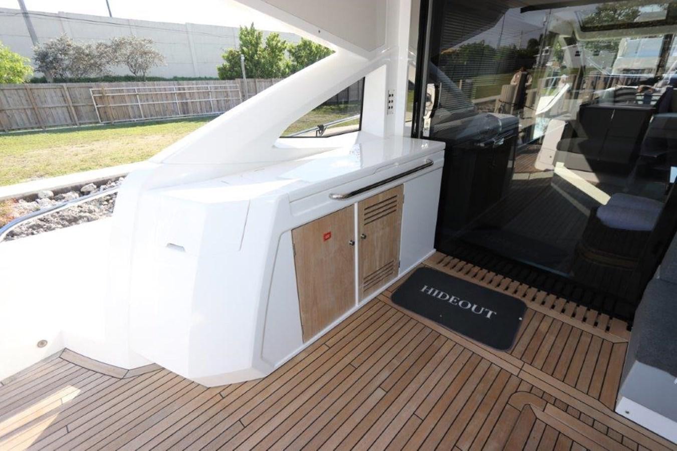 a large white machine on a wooden deck aboard HIDE OUT Yacht for Sale