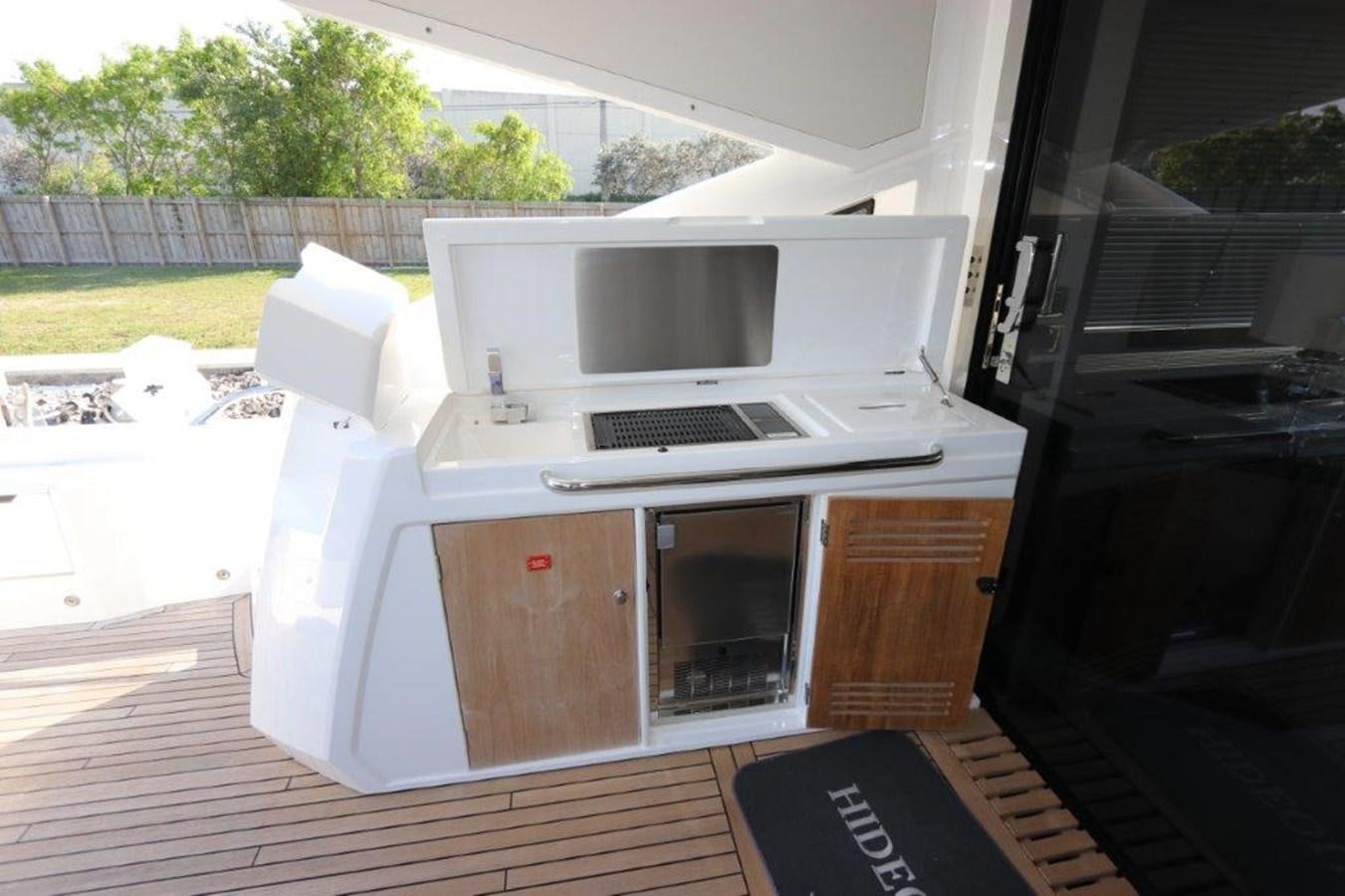 a white microwave on a wooden table aboard HIDE OUT Yacht for Sale