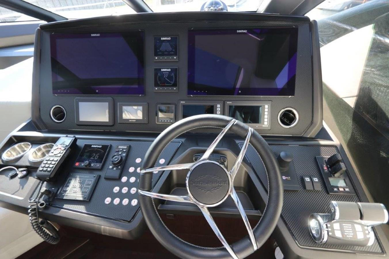 a car with a screen and a steering wheel aboard HIDE OUT Yacht for Sale