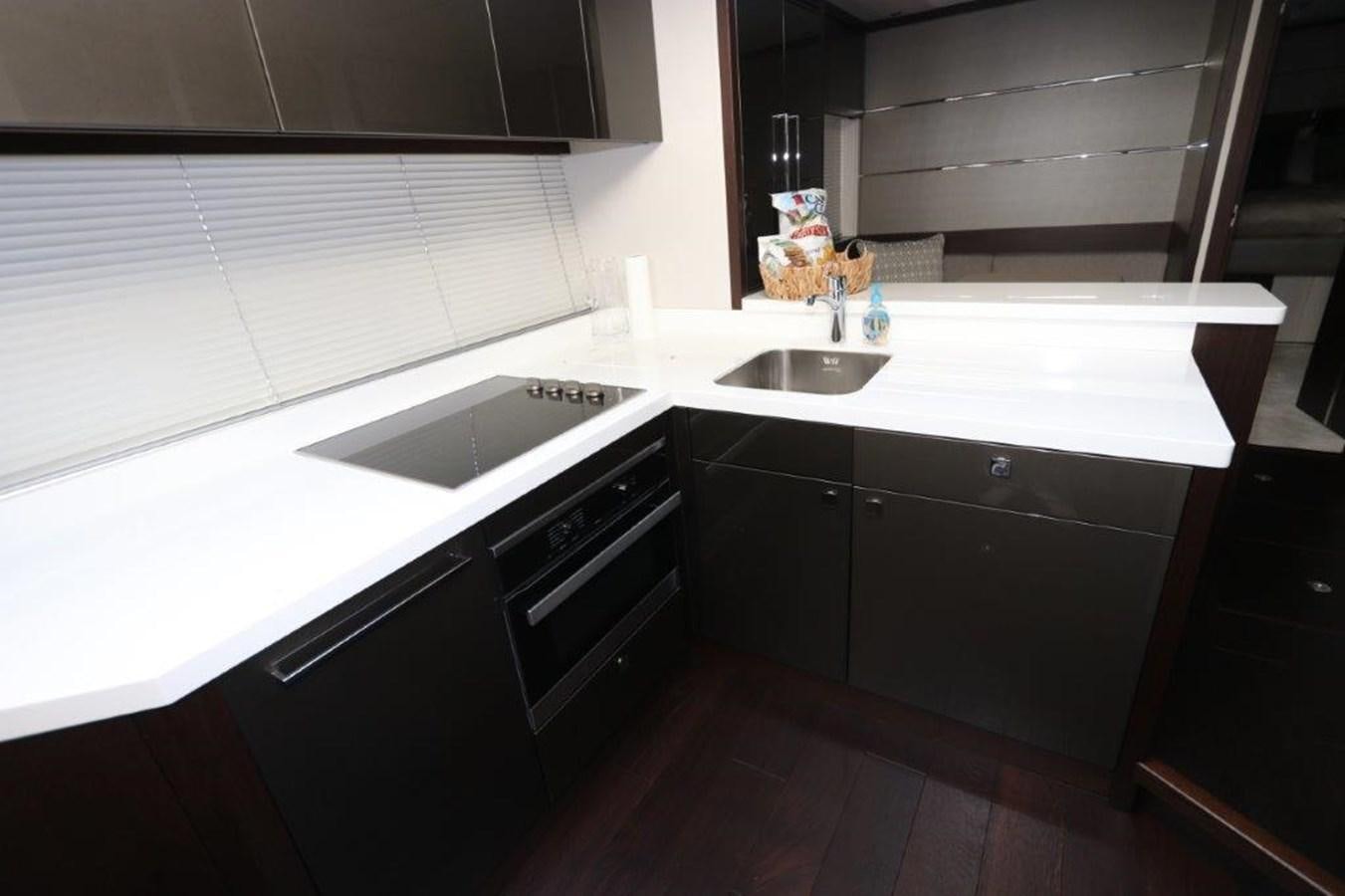 a kitchen with black cabinets aboard HIDE OUT Yacht for Sale