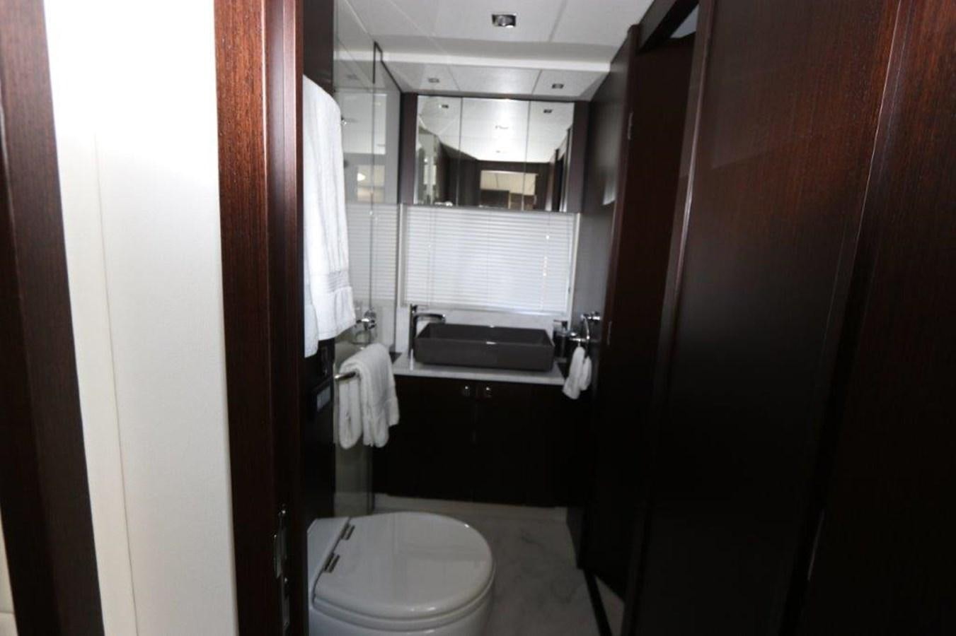 a bathroom with a toilet and a sink aboard HIDE OUT Yacht for Sale