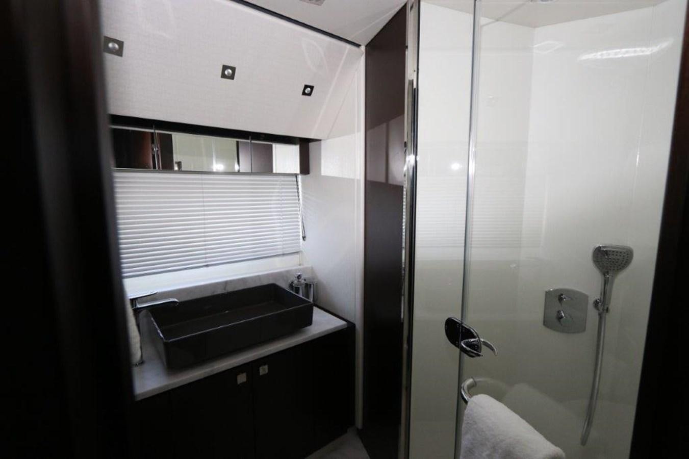 a bathroom with a shower and sink aboard HIDE OUT Yacht for Sale