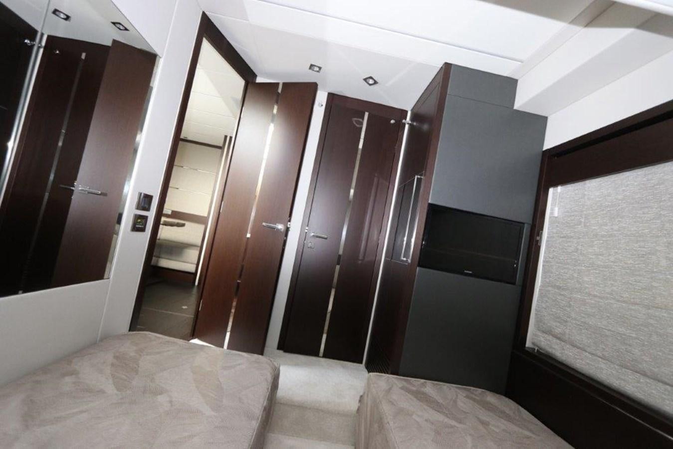 a room with a bed and closet aboard HIDE OUT Yacht for Sale