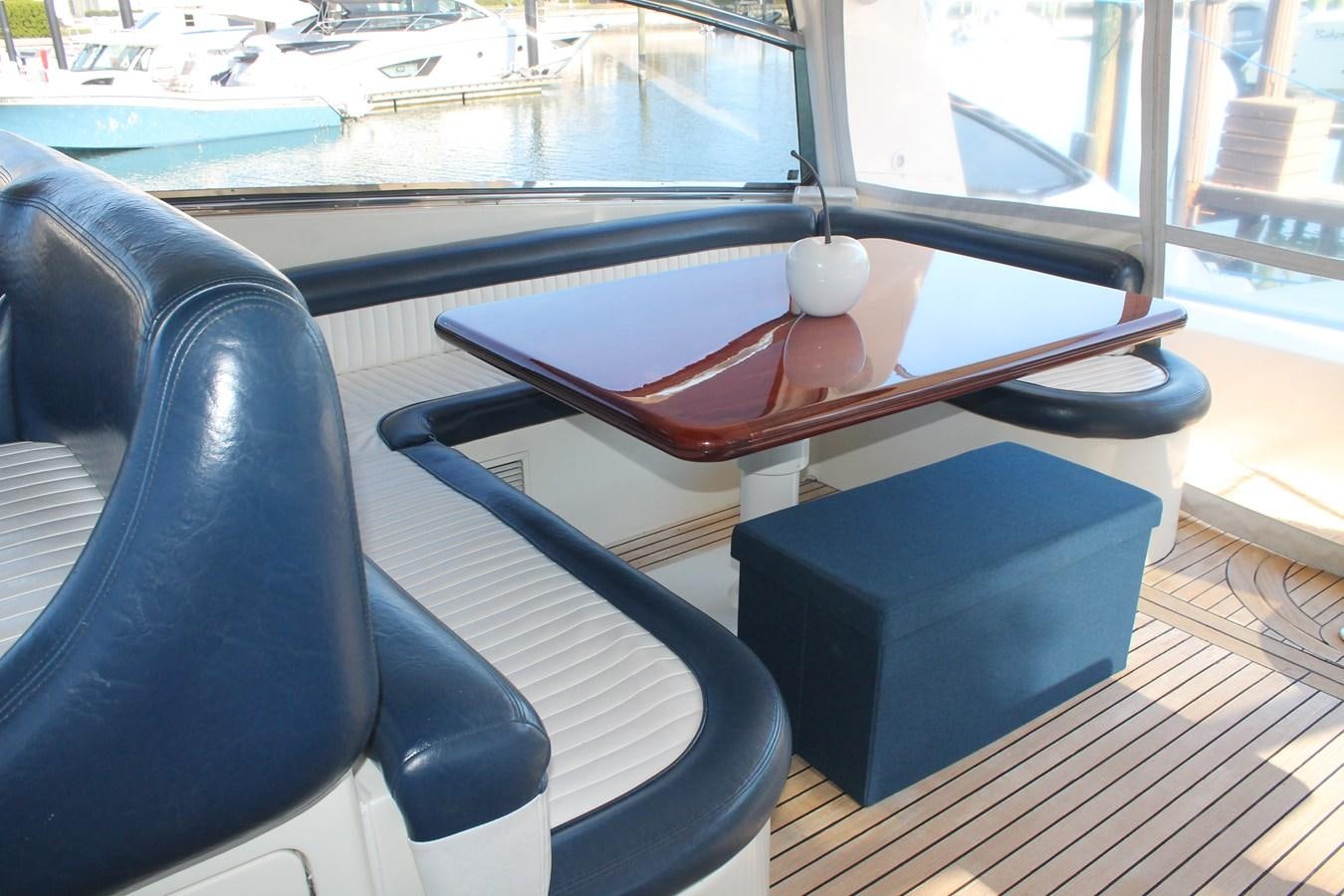 a black rectangular table with a red table and black chairs aboard MAGNIFICA Yacht for Sale