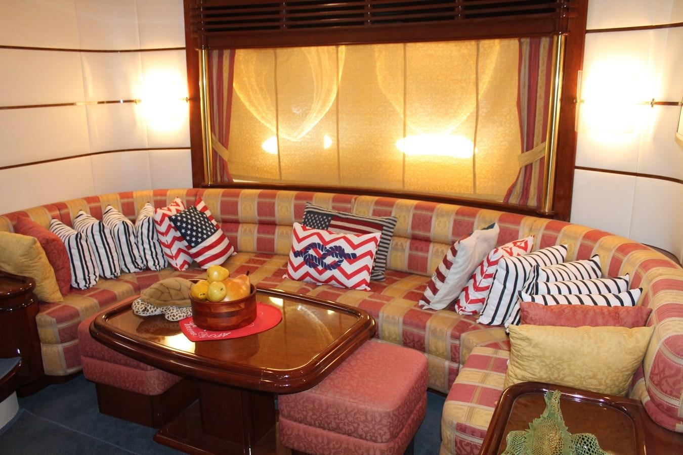 a living room with a couch and a table aboard MAGNIFICA Yacht for Sale
