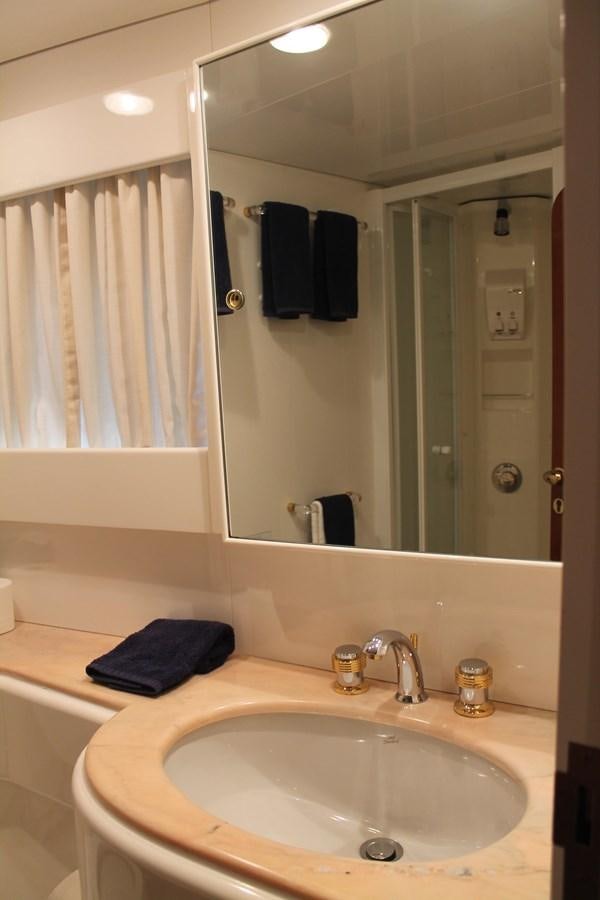 a bathroom with a sink and a mirror aboard MAGNIFICA Yacht for Sale