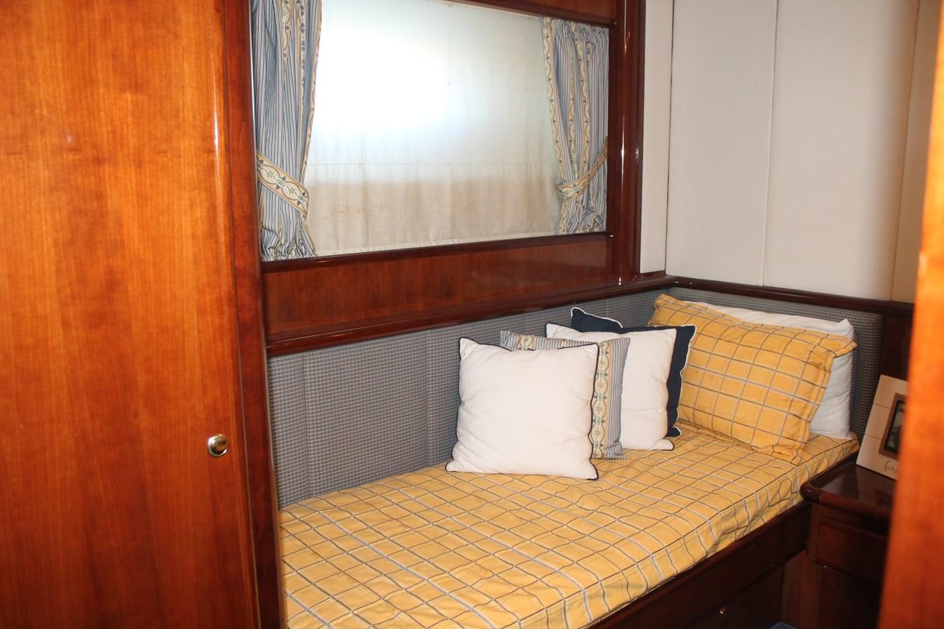 a bed with white pillows aboard MAGNIFICA Yacht for Sale