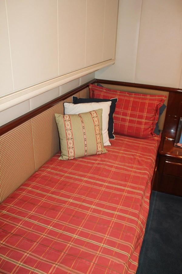 a bed with a red and white checkered blanket aboard MAGNIFICA Yacht for Sale