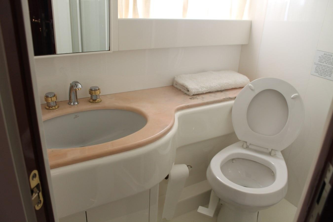 a bathroom with a toilet and sink aboard MAGNIFICA Yacht for Sale