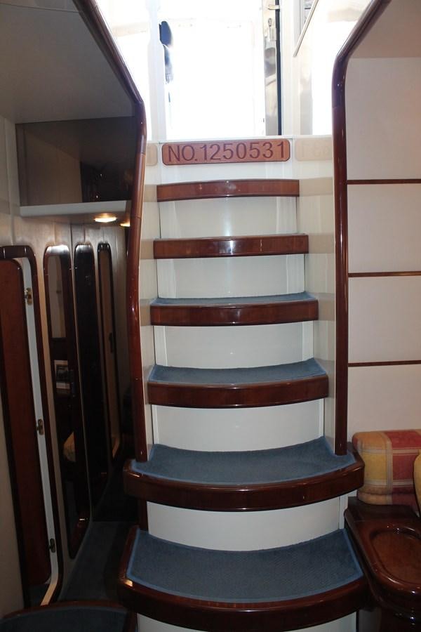 a staircase with a sign on the wall aboard MAGNIFICA Yacht for Sale