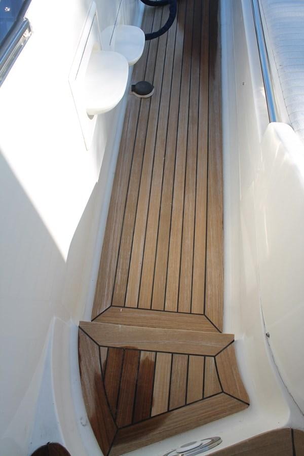 a wooden staircase with a light fixture aboard MAGNIFICA Yacht for Sale