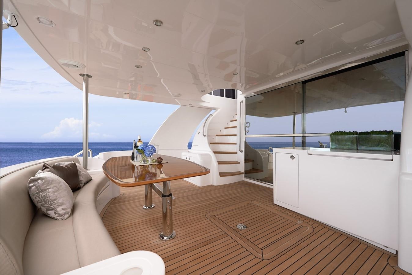 a room with a table and a couch aboard JUSTIFIED Yacht for Sale