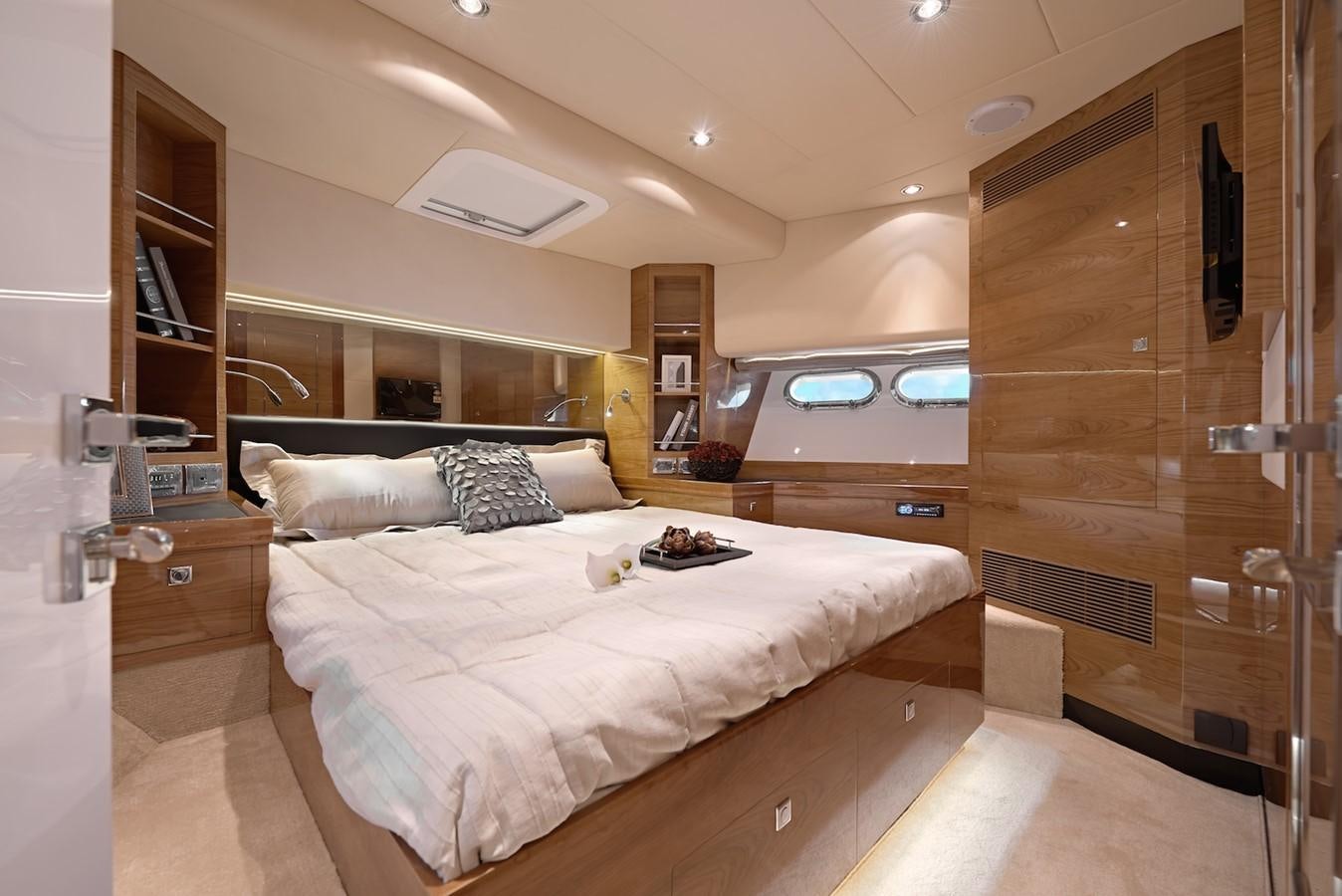 a bedroom with a bed and a glass wall aboard JUSTIFIED Yacht for Sale