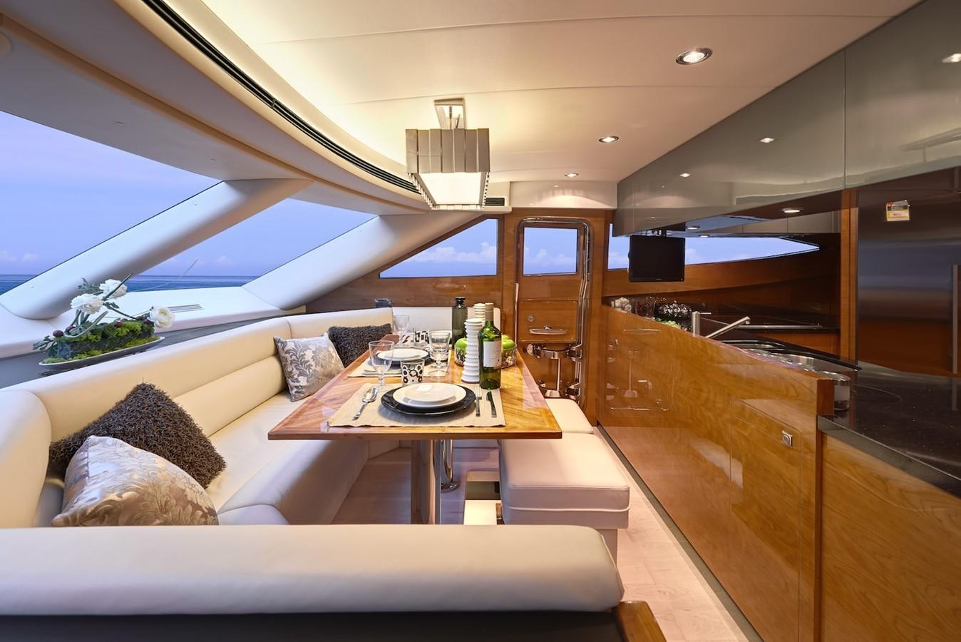 a room with a couch and a table with bottles on it aboard JUSTIFIED Yacht for Sale