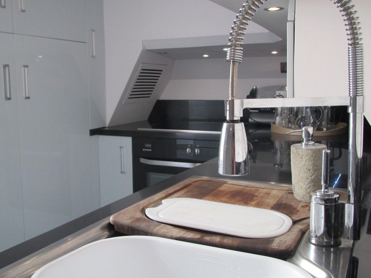 a kitchen with a sink and a large island aboard CASPA Yacht for Sale