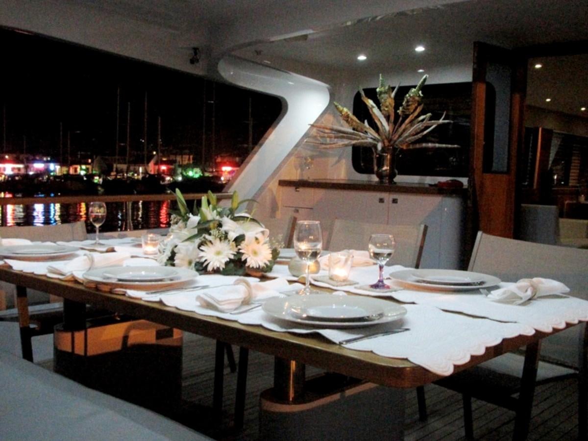 a table with plates and glasses aboard CASPA Yacht for Sale