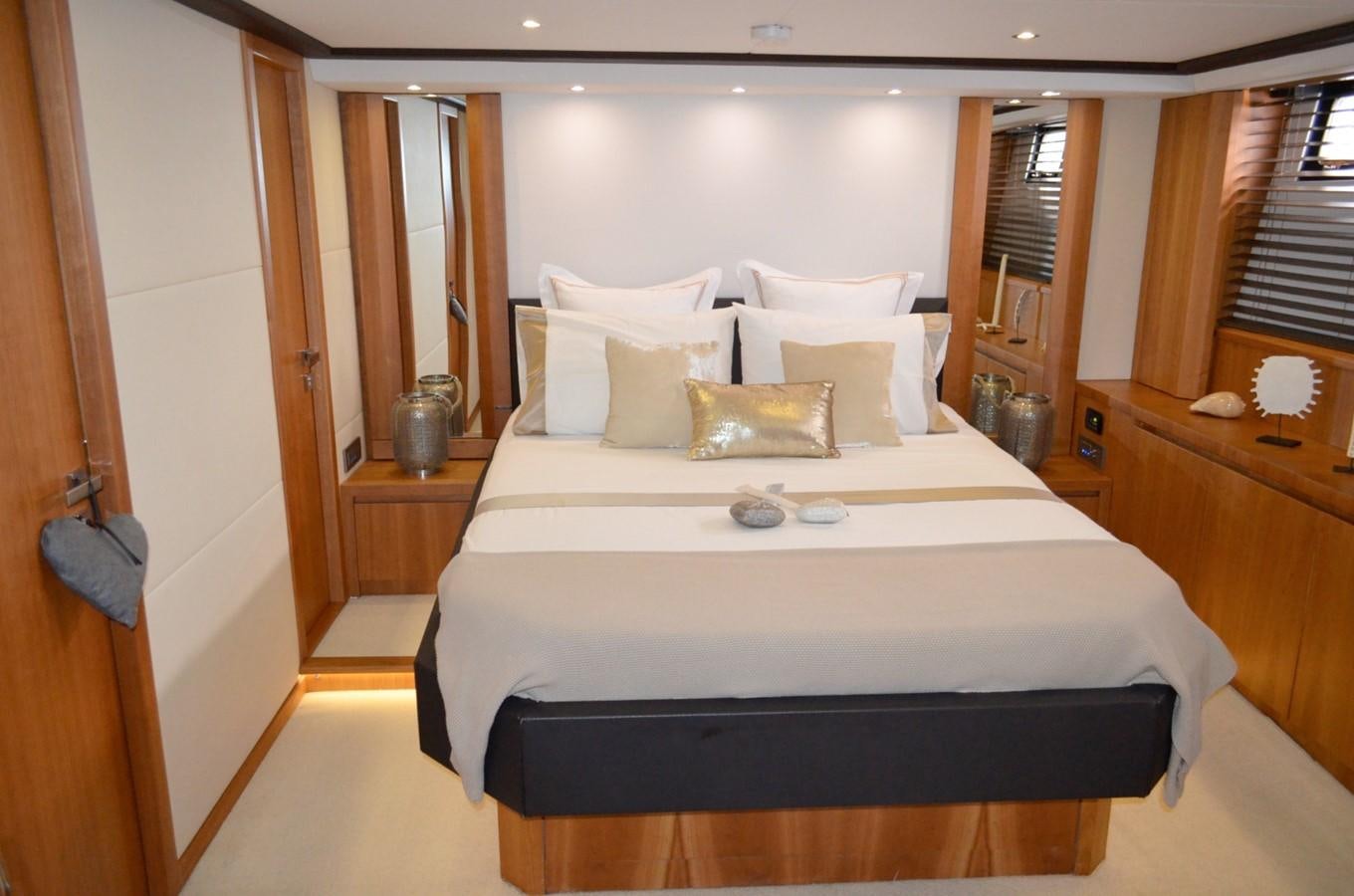 a bed with white sheets aboard CASPA Yacht for Sale