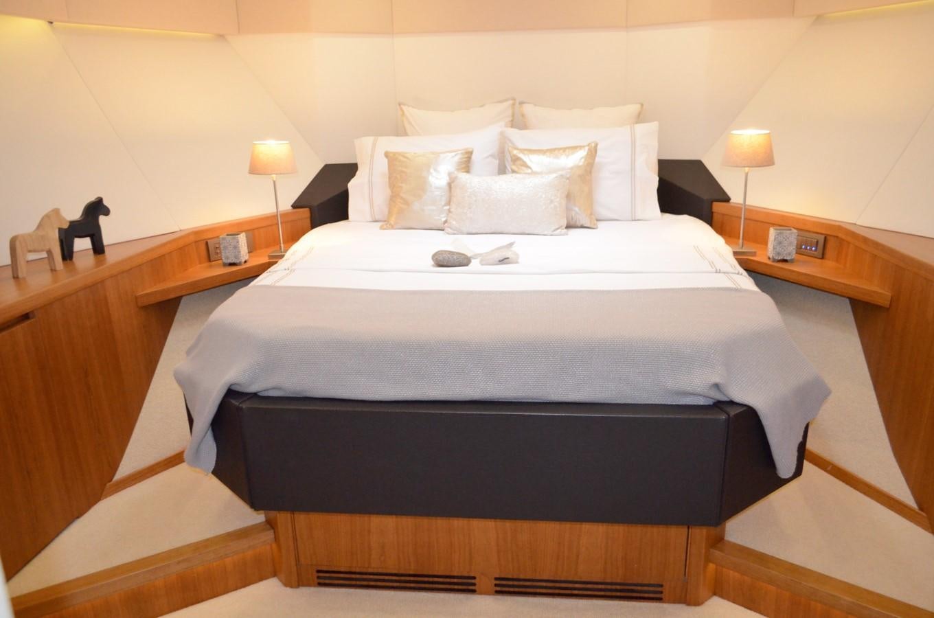 a bed with white sheets and pillows aboard CASPA Yacht for Sale