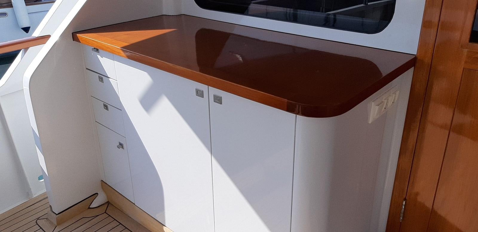 a white cabinet with drawers aboard CASPA Yacht for Sale