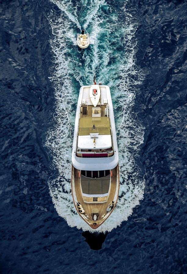 a small wooden boat in the water aboard CASPA Yacht for Sale