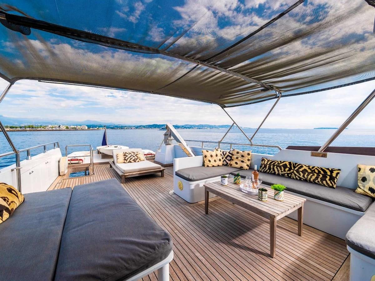 a room with a bed and a table on a deck aboard CASPA Yacht for Sale