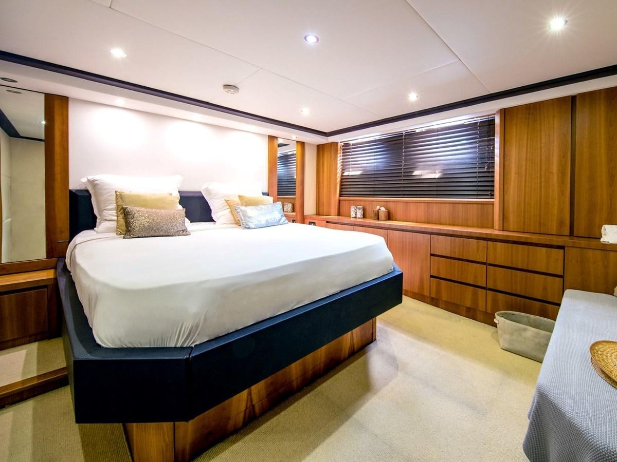 a room with a bed and a table aboard CASPA Yacht for Sale