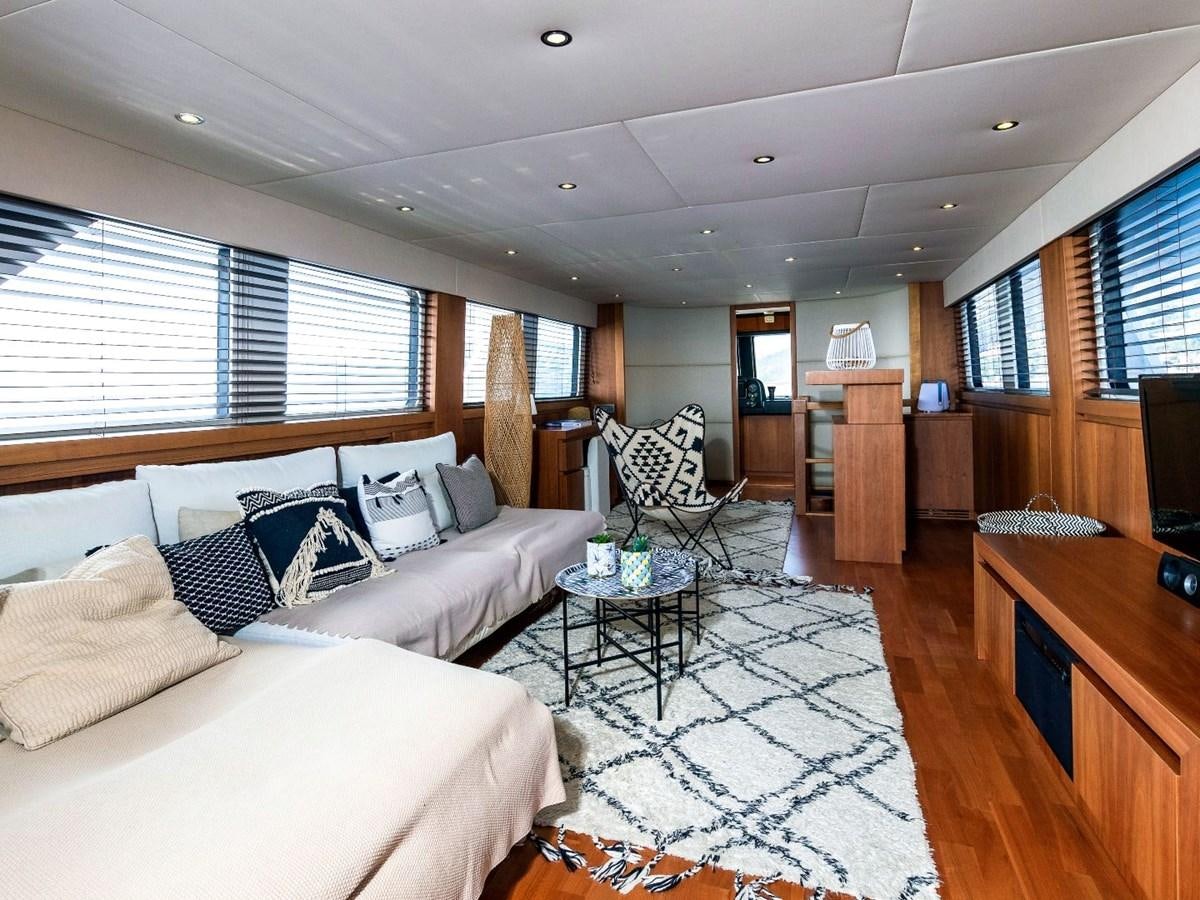 a living room with a large window aboard CASPA Yacht for Sale