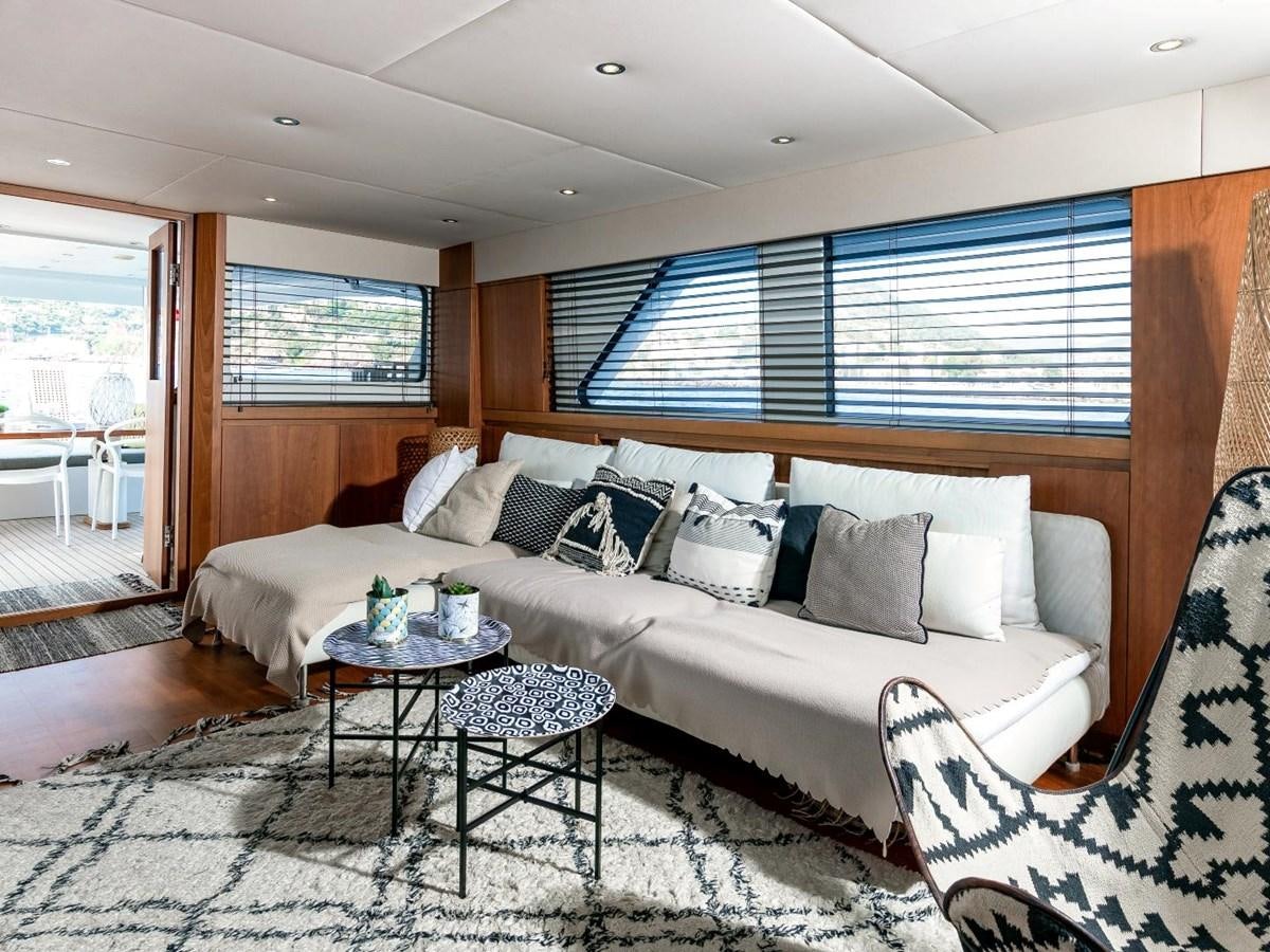 a living room with a couch and a table aboard CASPA Yacht for Sale
