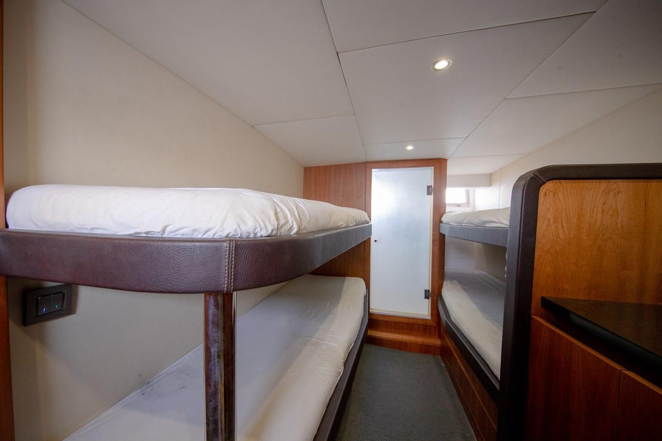 a room with a bed and a desk aboard CASPA Yacht for Sale