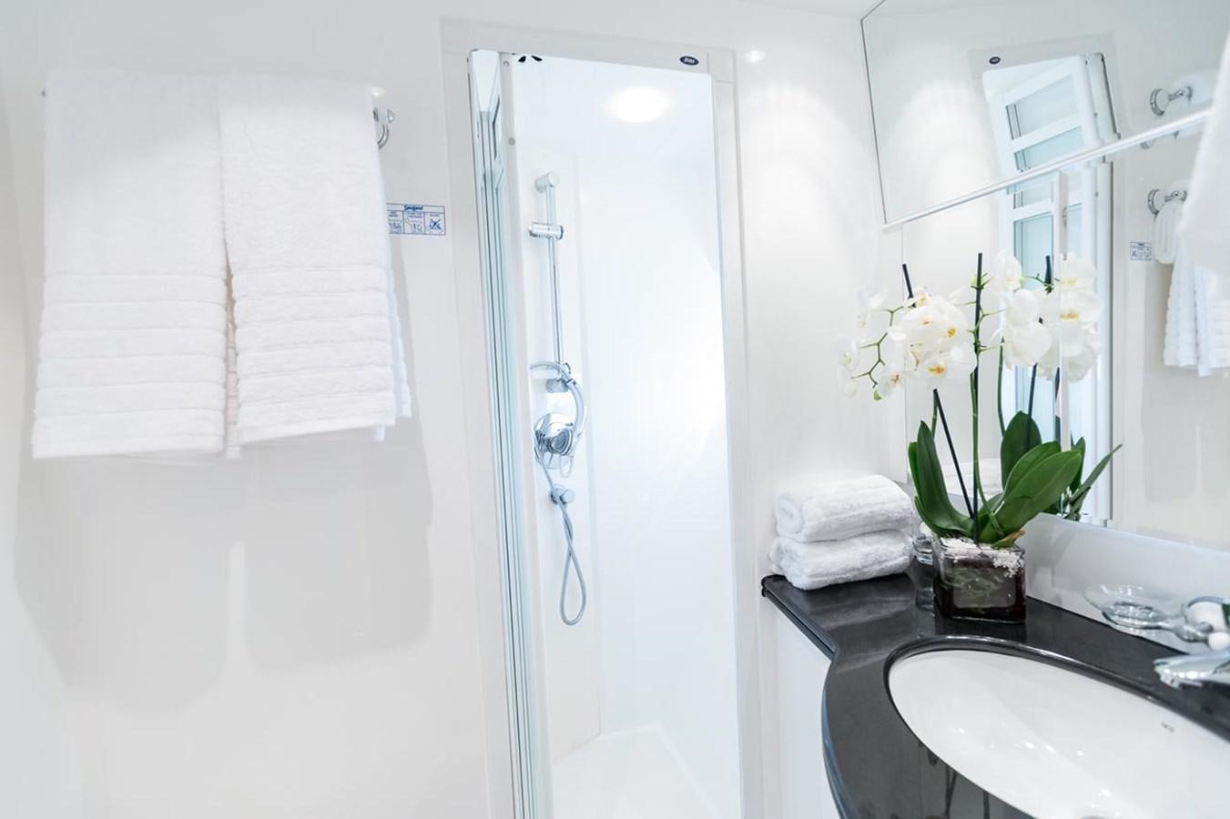 a bathroom with a sink and towels aboard MARLIN Yacht for Sale