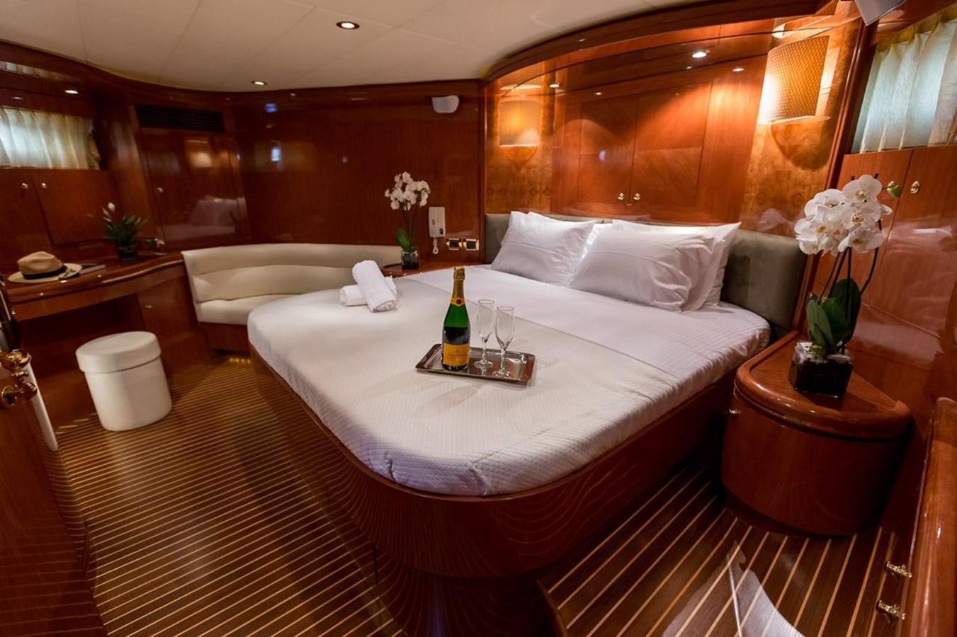 a room with a bed and a bottle of wine aboard MARLIN Yacht for Sale