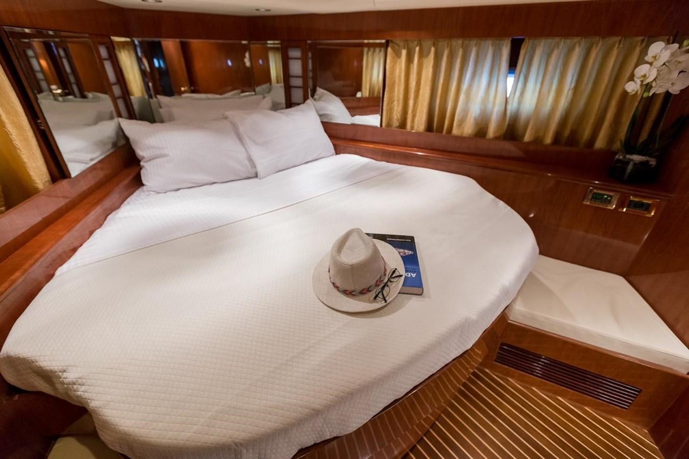 a bed with a white sheet and pillows aboard MARLIN Yacht for Sale