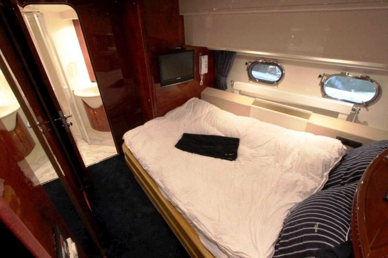 a hotel room with a bed and a television aboard THE RIVER Yacht for Sale