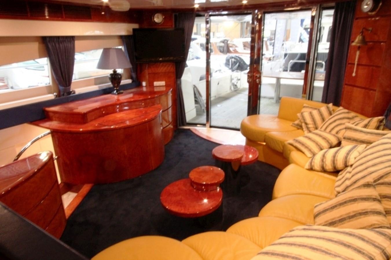a living room with a red table aboard THE RIVER Yacht for Sale