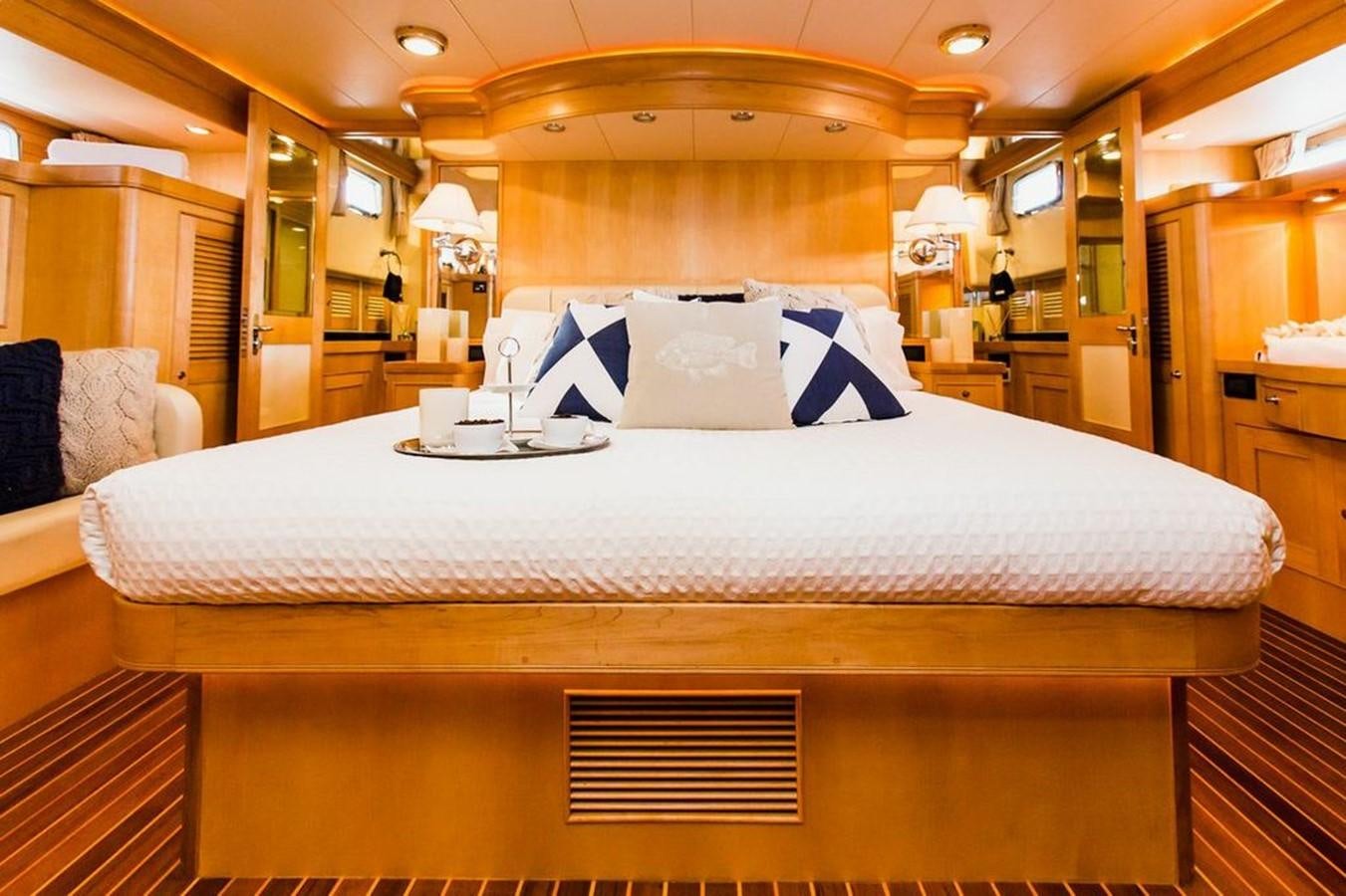 a bed with a white sheet and a white pillow on it aboard 72' MARLOW RAISED PILOTHOUSE MOTOR YACHT EXPLORER I Yacht for Sale