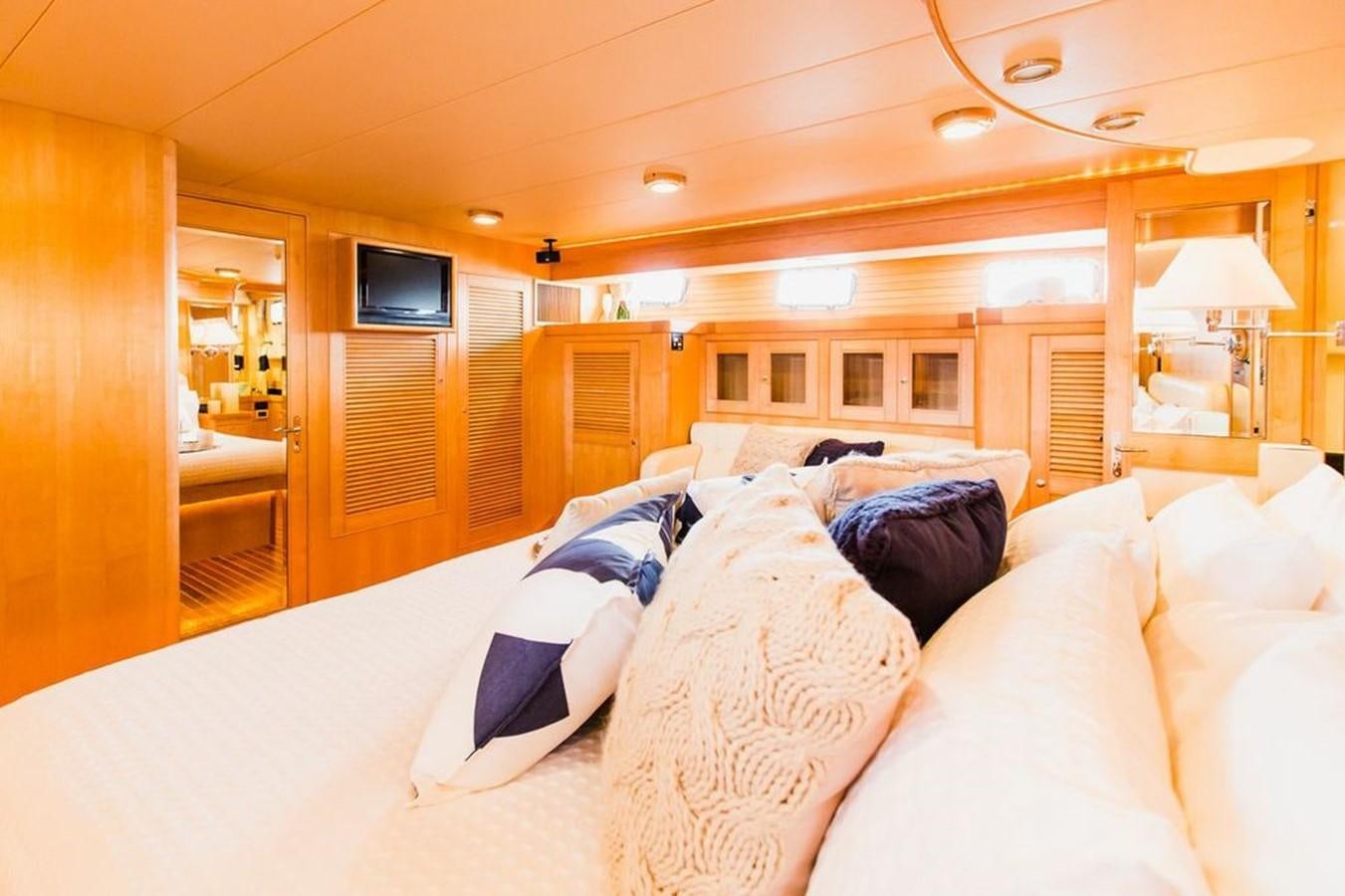 a bedroom with a bed and a television aboard 72' MARLOW RAISED PILOTHOUSE MOTOR YACHT EXPLORER I Yacht for Sale