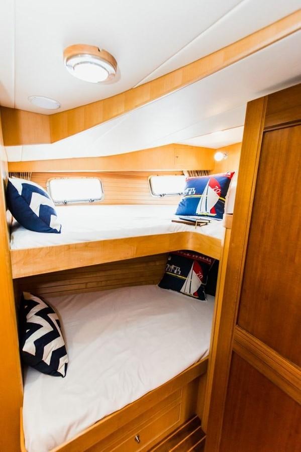 a bunk bed with a laptop on it aboard 72' MARLOW RAISED PILOTHOUSE MOTOR YACHT EXPLORER I Yacht for Sale
