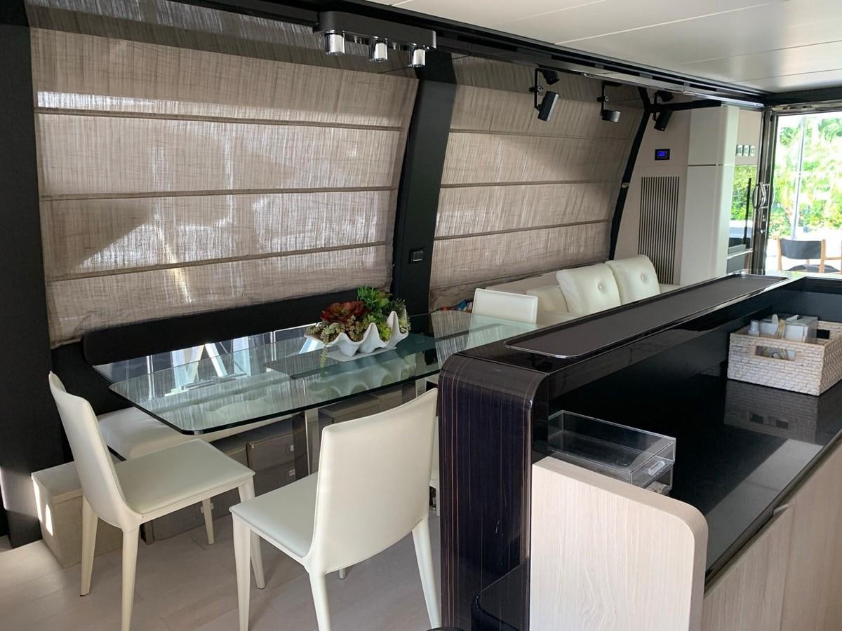 a room with a table chairs and a window aboard AMALFI Yacht for Sale