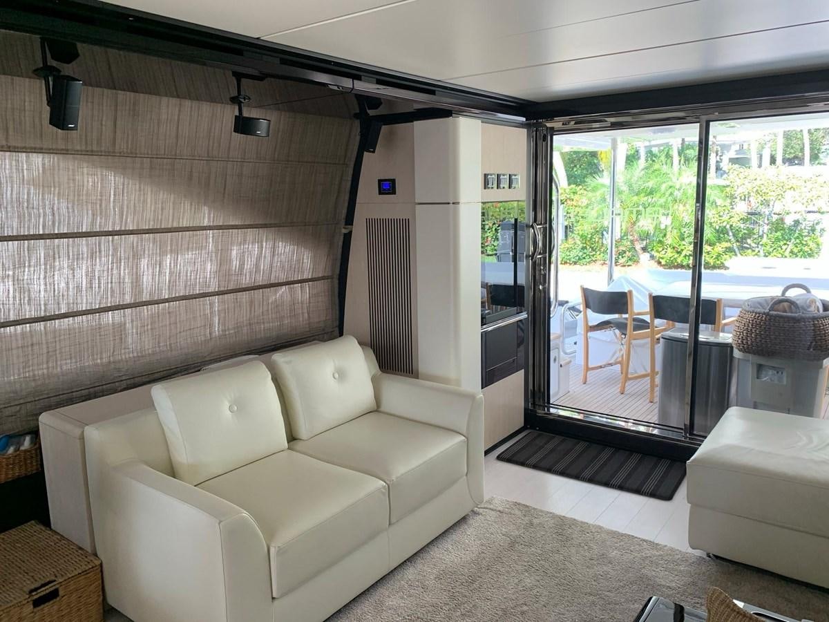 a living room with a sliding glass door aboard AMALFI Yacht for Sale