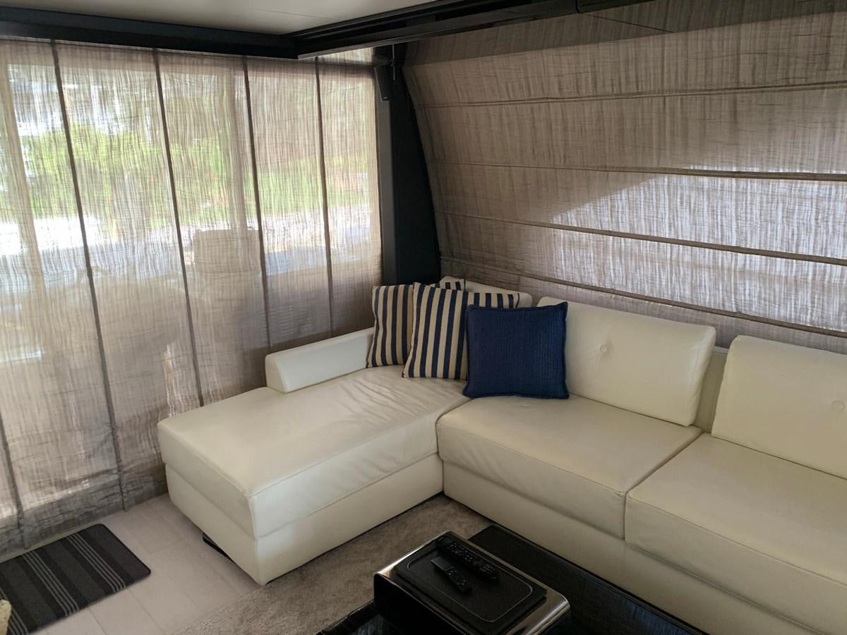 a couch and a table in a room aboard AMALFI Yacht for Sale