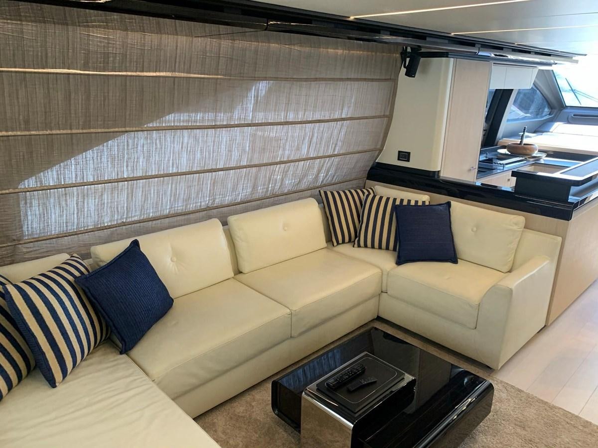 a living room with a couch and a coffee table aboard AMALFI Yacht for Sale