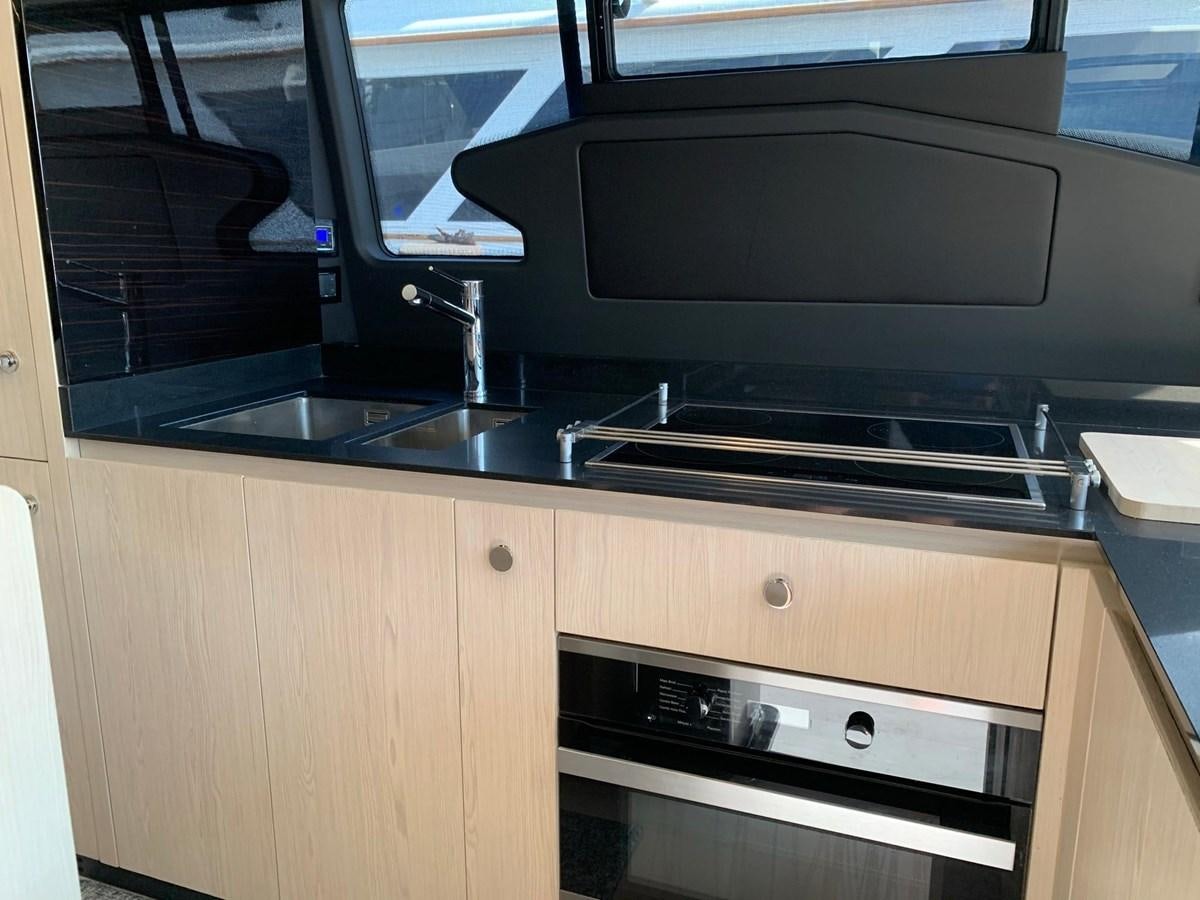 a kitchen with a microwave oven and a sink aboard AMALFI Yacht for Sale