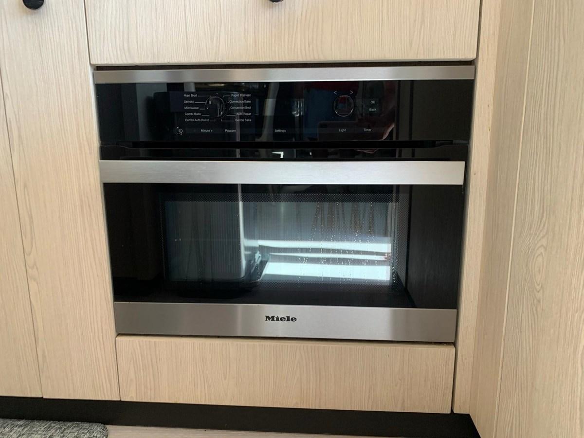 a microwave oven in a wooden cabinet aboard AMALFI Yacht for Sale