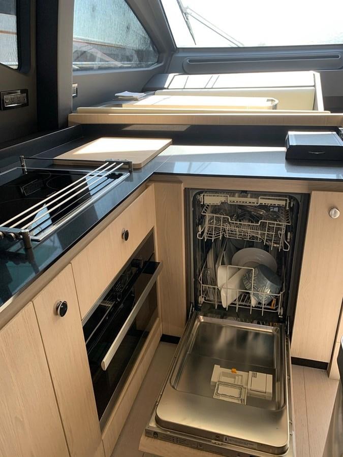 a kitchen with a stove and oven aboard AMALFI Yacht for Sale
