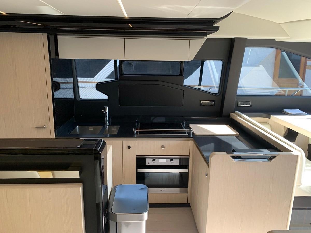 a kitchen with a microwave oven and cabinets aboard AMALFI Yacht for Sale